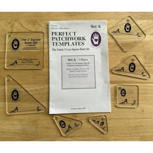 May include: A set of seven clear acrylic quilting templates labelled Set A, including various geometric shapes with printed markings and a white instruction sheet titled Perfect Patchwork Templates, The 7.5 cm Square Basic Set, Product Number 8251.