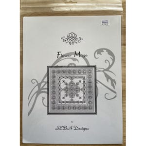 May include: A white paper with the title "Flower Maze" and a detailed floral design in a square frame. The design is black and white, with the words "SEBA Designs" at the bottom.
