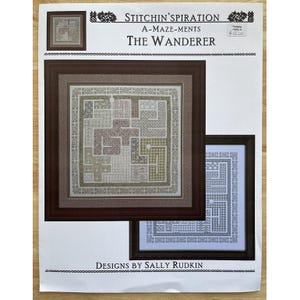 May include: A cross-stitch pattern titled "The Wanderer" by Sally Rudkin. The design features a maze-like pattern in shades of green, brown, and beige, framed in a dark brown border. The text "Stitchin'spiration" is at the top.