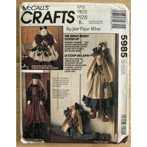 May include: McCall's Crafts pattern for bunny cover-ups. The pattern includes instructions for sewing machine covers, vacuum cleaner covers, and draft blockers. The image shows several examples of the finished bunny designs, with text in English and French.