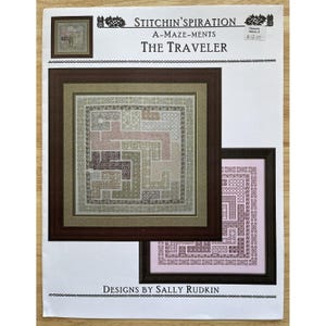 May include: A framed cross-stitch pattern titled "The Traveler" by Sally Rudkin. The design features a geometric maze in shades of green, pink, and beige. The image includes the text "Stitchin'spiration" and "A-Maze-ments".