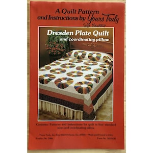 May include: A quilt pattern and instructions by Yours Truly. The image shows a Dresden Plate quilt and coordinating pillow. The quilt features a white background with colorful circular designs. The cover also includes text about the contents and product information.