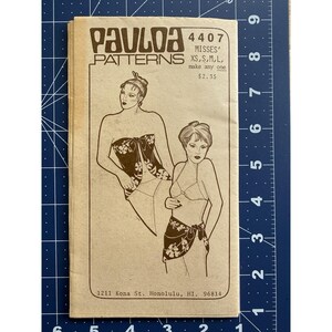 May include: A vintage sewing pattern titled "PAULOA PATTERNS 4407" for Misses' sizes XS, S, M, and L. The pattern features illustrations of lingerie designs. The address 1211 Kona St. Honolulu, HI, 96814 is printed at the bottom.