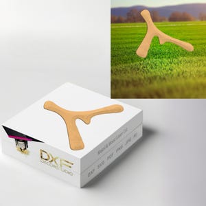 May include: A light brown wooden boomerang, with a curved shape and a notched design. The boomerang is displayed on a white box with the text "DXF DECORSTUDIO" and "Metal & Wood Laser Cut". The image also shows the boomerang on a green grassy field.