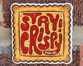May include: A yellow and brown sticker with a white border and a scalloped edge. The sticker features a red and white design that says "Stay Crispy!" with green accents. The sticker also includes the text "T-Rav STL".