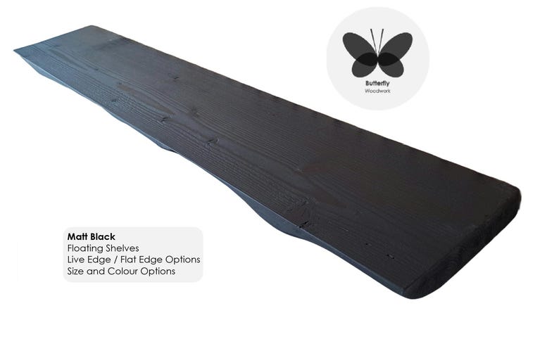 May include: A black wooden floating shelf with a live edge. The shelf is made of reclaimed wood and has a natural, rustic look. The text "Matt Black" is visible in the image. The text "Floating Shelves" is visible in the image. The text "Live Edge / Flat Edge Options" is visible in the image. The text "Size and Colour Options" is visible in the image.