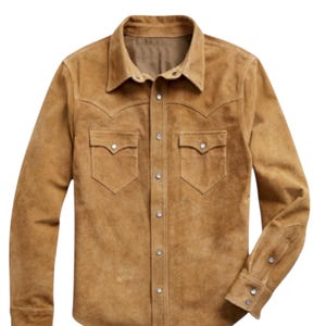 May include: A tan suede shirt with a classic Western design. The shirt features a pointed collar, two chest pockets with decorative flaps, and snap closures. The long sleeves have buttoned cuffs. A stylish addition to any wardrobe.