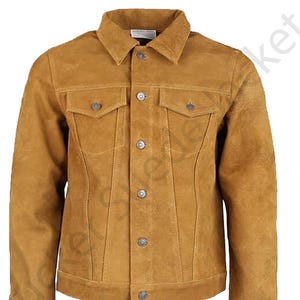 May include: A tan suede jacket with a classic design. The jacket features a collared neckline, two chest pockets, and a button-down front. The jacket has a tailored fit and is made of a soft, textured material. The jacket has silver buttons.