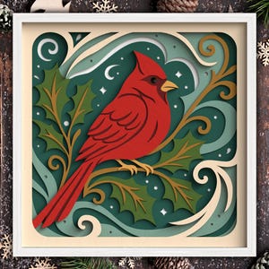 May include: A layered paper art piece featuring a vibrant red cardinal perched on a branch with green holly leaves. The artwork is set against a teal background with white accents and is framed in a white square.