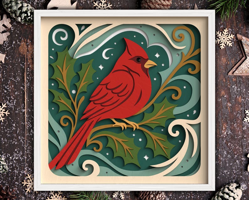 May include: A layered paper art piece featuring a vibrant red cardinal perched on a branch with green holly leaves. The artwork is set against a teal background with white accents and is framed in a white square.