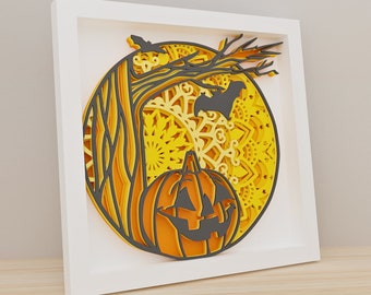 May include: A layered paper art piece in a white frame, featuring a Halloween theme. The design includes a carved pumpkin, a tree, and a bat silhouette against a yellow circular background. The artwork uses shades of orange, yellow, and gray.