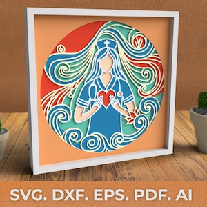 Puede incluir: Un diseño de archivo de corte digital de una enfermera con un corazón en sus manos. La enfermera está rodeada de un diseño floral azul y verde. El diseño es perfecto para crear una artesanía de papel en capas.