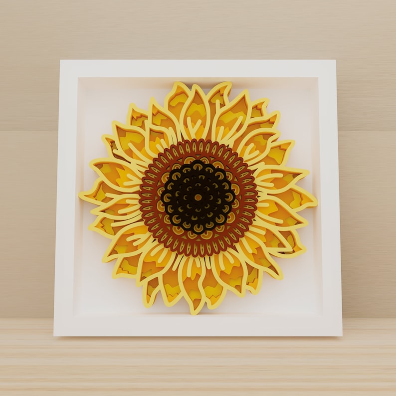 K&ouml;nnte beinhalten: Ein wei&szlig;er Rahmen mit einem gelben und braunen Papier-Ausschnitt-Sonnenblumen-Design. Die Sonnenblume hat eine detaillierte Mitte mit einem braunen und schwarzen Muster.
