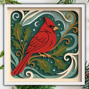 May include: A layered paper art piece featuring a vibrant red cardinal perched on a branch with holly leaves. The artwork is set against a teal background with white accents and a white frame, evoking a festive, nature-inspired theme.