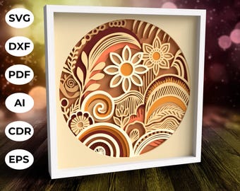 May include: A white frame with a beige background and a circular design in shades of orange, brown, and white. The design features intricate swirls, flowers, and leaves.