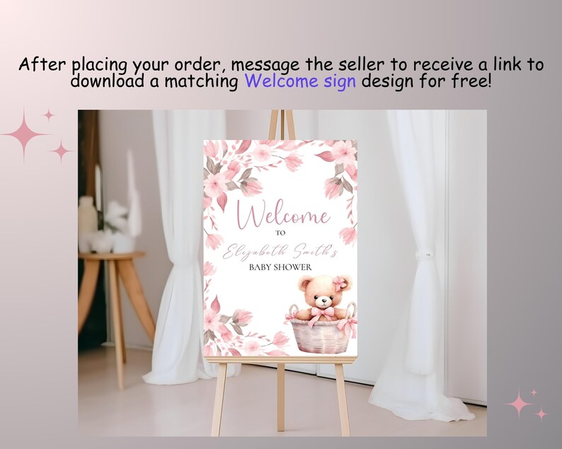 May include: A pink and white welcome sign with floral designs and a teddy bear in a basket. The sign reads "Welcome to Elizabeth Smiths Baby Shower".