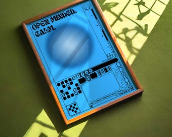 May include: A framed art print with a blue background and a wooden frame. The print features the words "OPEN-MINDED. CALM." in black text. The print has a circular design and various geometric shapes. The print is on a green surface.