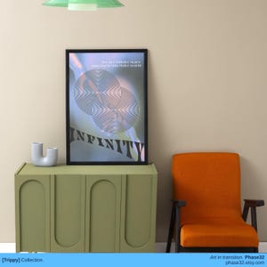 Poster displayed above a green sideboard and orange chair in a minimalist beige room.