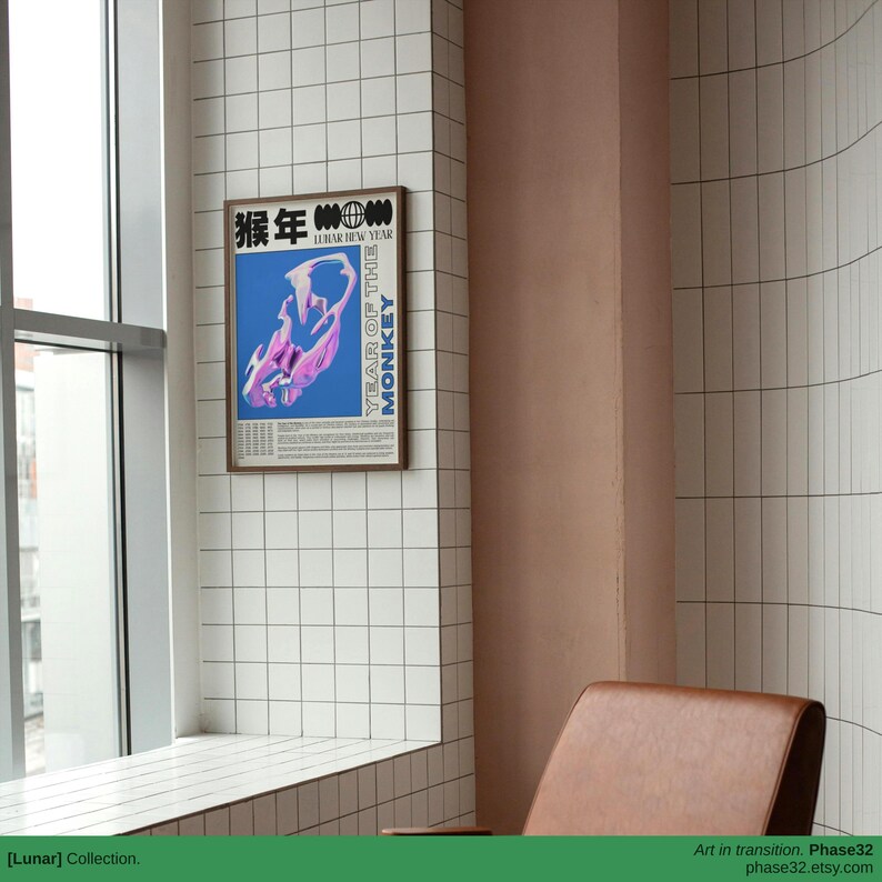 Poster hung on a clean, curved wall beside a modern chair, highlighting its bold typography and surreal monkey form.