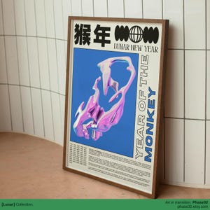 Side-by-side framed posters including “Year of the Monkey,” displayed in a dark gallery-style room with glowing neon reflections.