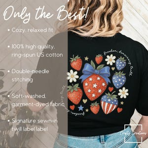 May include: Black t-shirt featuring a patriotic strawberry design with stars and stripes, surrounded by flowers and hearts. The text "freedom, democracy, truth" is arched above the design. The shirt has a relaxed fit and is made of soft, garment-dyed fabric.