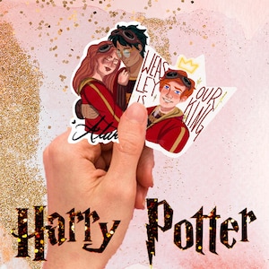 May include: A hand holds three Harry Potter-themed stickers. The stickers feature illustrations of characters in red and gold robes. One sticker says "Weasley is our King." The background is pink with gold glitter.