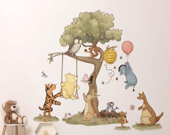 Op de afbeelding: Een grillige muursticker met Winnie de Poeh en zijn vrienden. De scène toont een boom met een schommel, een bijenkorf en een roze ballon. Personages zijn onder meer Poeh, Tijger, Iejoor, Uil, Knorretje, Kanga, Roe en een eekhoorn.