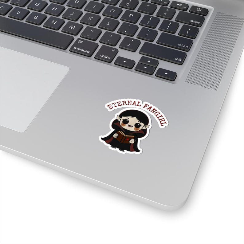 Sticker shaped like a black Puerto Rico license plate with the word "Bayamón", Isla del Encanto phrase, and Puerto Rican flags on both sides. 2in sticker with white outline on a laptop for reference.
