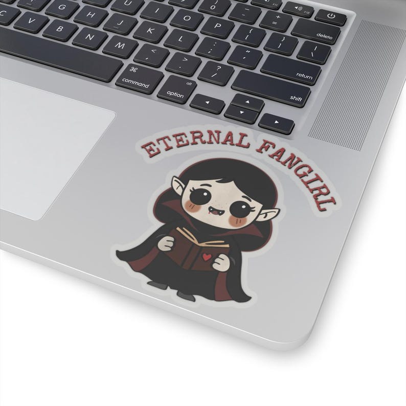Sticker shaped like a black Puerto Rico license plate with the word "Bayamón", Isla del Encanto phrase, and Puerto Rican flags on both sides. 4in sticker with transparent outline on a laptop for reference.