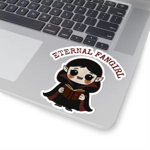 Sticker shaped like a black Puerto Rico license plate with the word "Bayamón", Isla del Encanto phrase, and Puerto Rican flags on both sides. 4in sticker with white outline on a laptop for reference.