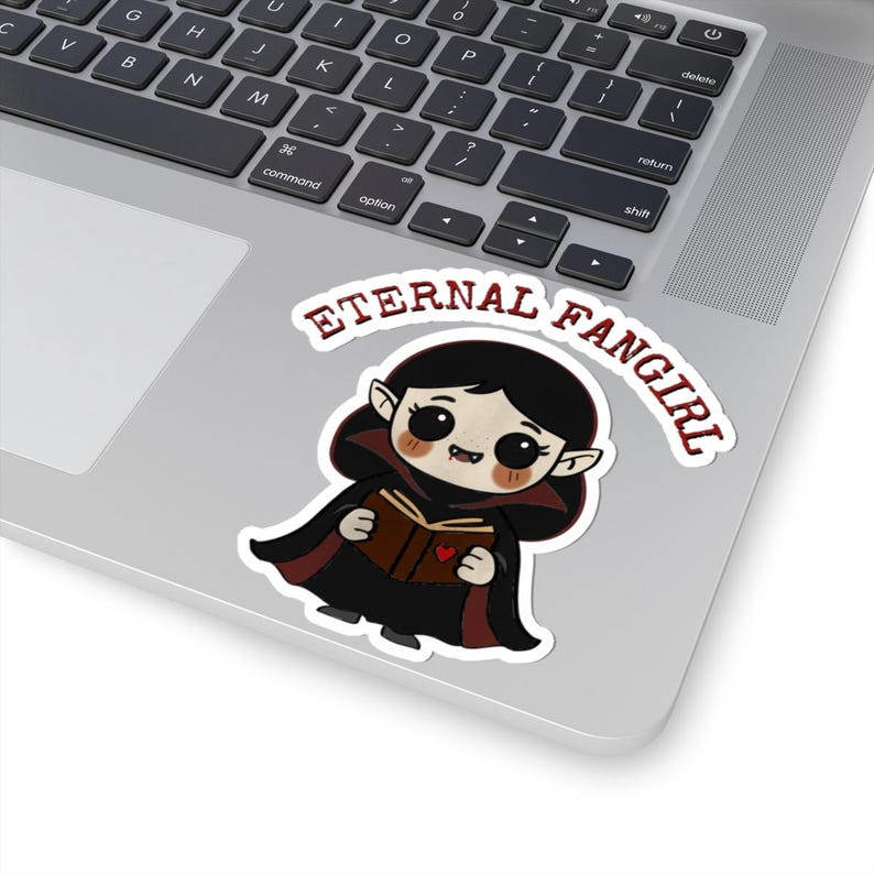 Sticker shaped like a black Puerto Rico license plate with the word "Bayamón", Isla del Encanto phrase, and Puerto Rican flags on both sides. 4in sticker with white outline on a laptop for reference.