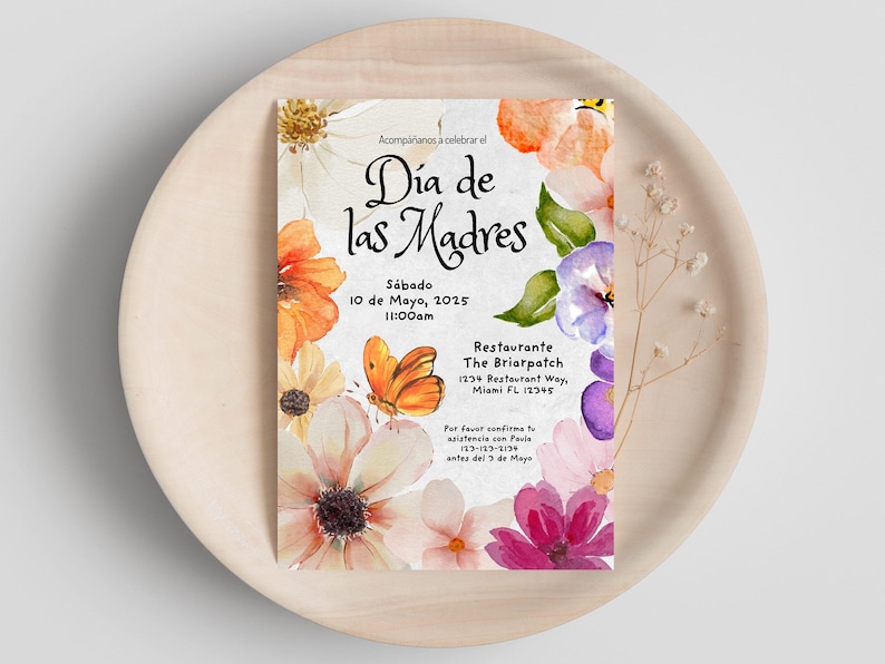 May include: A watercolor invitation with floral designs in shades of pink, purple, orange, and yellow. The invitation is for a Mother's Day celebration on Saturday, May 10th, 2025 at 11:00 am at The Briarpatch restaurant. The text reads "Acompáñanos a celebrar el Día de las Madres" and includes the restaurant's address and contact information.