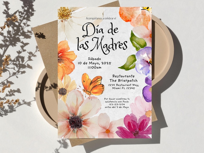 May include: A floral invitation for a Mother's Day celebration at The Briarpatch restaurant. The invitation features watercolor flowers in shades of pink, purple, orange, and yellow. The text reads "D&iacute;a de las Madres" and includes the date, time, and location of the event.