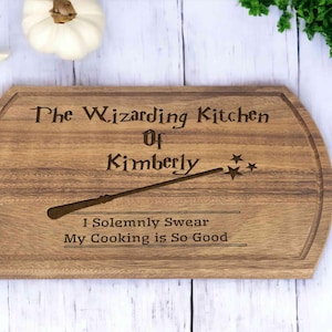 May include: A wooden cutting board with the text "The Wizarding Kitchen of Kimberly" and "I Solemnly Swear My Cooking is So Good" engraved on it. A wand with stars is also engraved on the board.