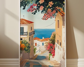 Puede incluir: Una pintura enmarcada que representa una escena de calle colorida y soleada en un pueblo mediterráneo. La calle está bordeada de edificios blancos y flores rosas vibrantes. El océano es visible en la distancia.