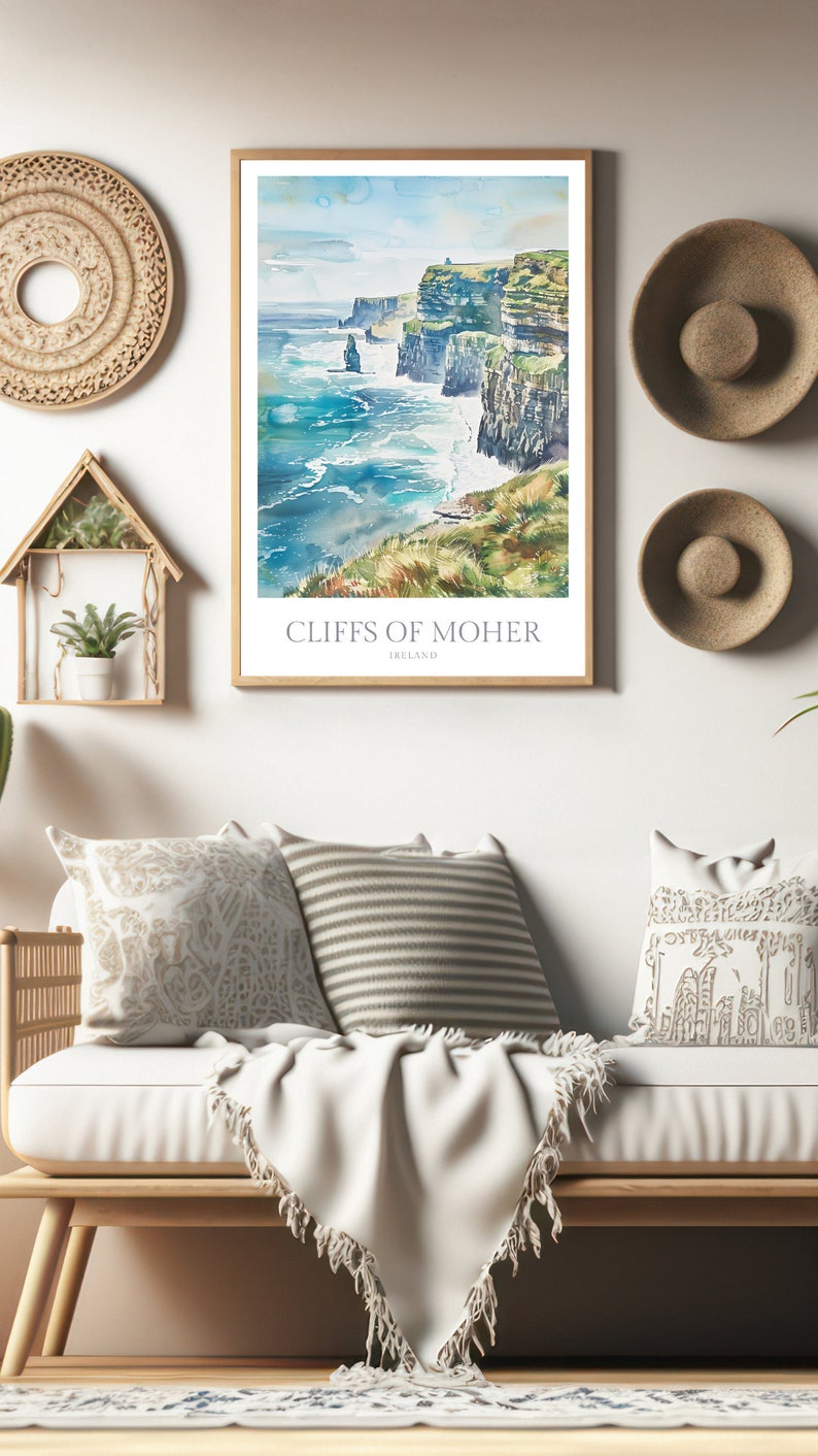 May include: A watercolour painting of the Cliffs of Moher in Ireland. The painting depicts the cliffs rising up from the sea, with waves crashing against the rocks. The sky is a light blue, with some clouds. The painting is framed in a wooden frame.