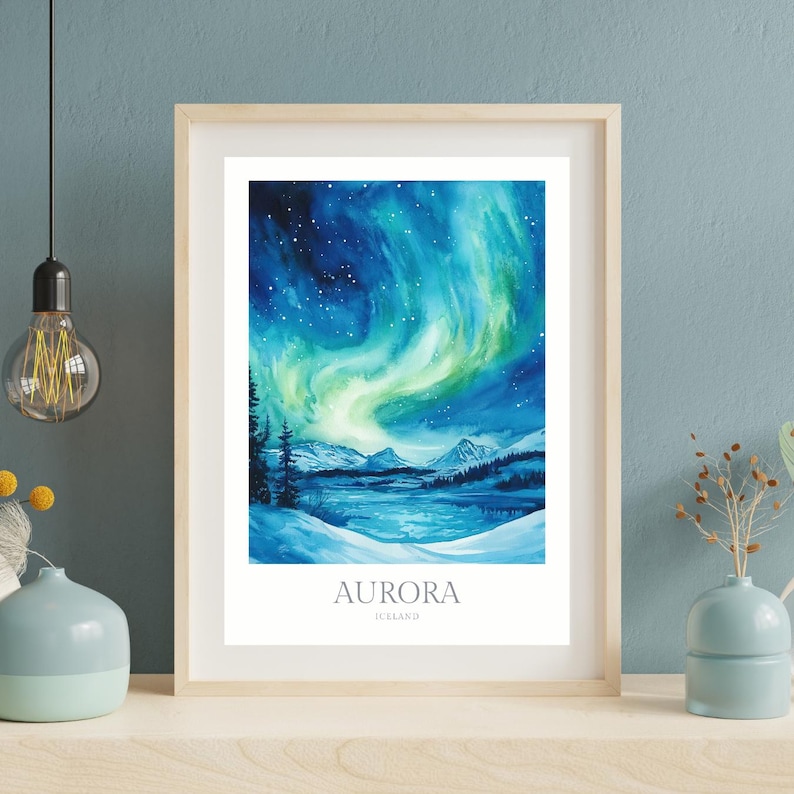 May include: A watercolor painting of the aurora borealis over a snowy landscape in Iceland. The sky is a deep blue with swirling green and yellow lights. The text "AURORA ICELAND" is at the bottom of the painting.