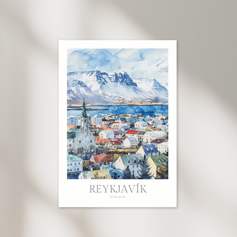 May include: A watercolor painting of the city of Reykjavik, Iceland. The painting shows a cityscape with a church steeple, colorful buildings, and snow-capped mountains in the background.