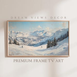 May include: A framed painting of a snowy mountain landscape with skiers in the foreground. The painting is in a light wood frame and has a blue sky with white clouds.