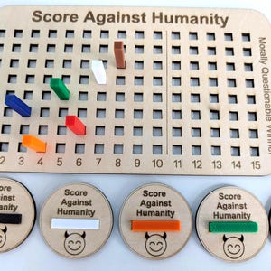May include: A wooden board game titled "Score Against Humanity" with a grid and colored pegs. Includes wooden tokens with the game's name and a smiling devil face. The game board has the text "Morally Questionable Winner".