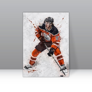 May include: A hockey player wearing an orange and black jersey with the number 97 on the back. The player is holding a hockey stick and is in a skating position. The background is a white and gray abstract design.