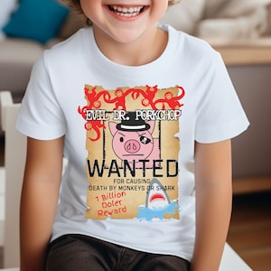May include: White t-shirt featuring a cartoon image of a pig wearing a top hat and an eye patch. The image is a wanted poster with the text "EVIL DR. PORKCHOP WANTED" and "DEATH BY MONKEYS OR SHARK 1 Billion Doler Reward".