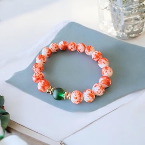 Orange and green glass bracelet,green and orange beaded bracelet,glass orange splatter beads, stretch roll on stackable layering bracelet