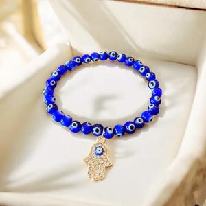 Blue glass evil eye beaded bracelet with hamsa hand pave charm