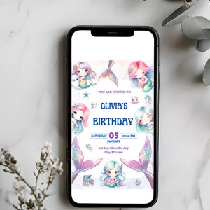 May include: A smartphone displays a digital birthday invitation. The invitation features illustrations of mermaids with colorful hair and mermaid tails. Text on the invitation reads "Olivia's Birthday" and includes date, time, and address details.