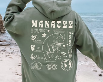 May include: A green hooded sweatshirt with a white graphic print of a manatee, the words "Manatee", "Sea Cow", and other facts about the animal. The graphic also includes a stylized image of the Earth and the words "Save the Ocean".