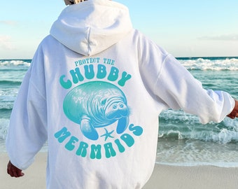 May include: White hoodie with a blue and green graphic of a manatee with the text "Protect the Chubby Mermaids" on the back.