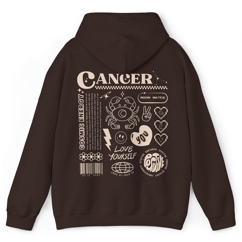May include: Brown hooded sweatshirt with a graphic print of the zodiac sign Cancer. The print includes the words "Cancer", "Cosmic Energy", "Moon Water", "Love Yourself", and "Positive".