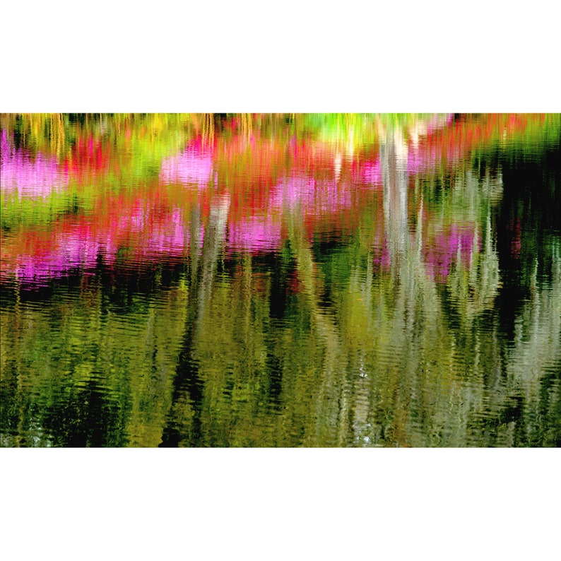 May include: Abstract photo of a reflection of pink and green colors in a still body of water. The colors are blurred and create a dreamy, artistic effect.