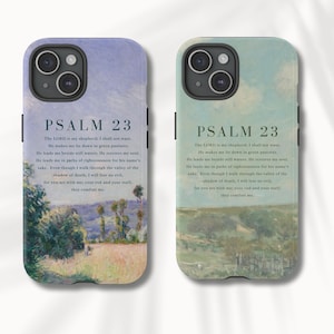 May include: Two phone cases with a painting of a landscape and the text "PSALM 23" and the text of the psalm. The phone cases are white with a black border.